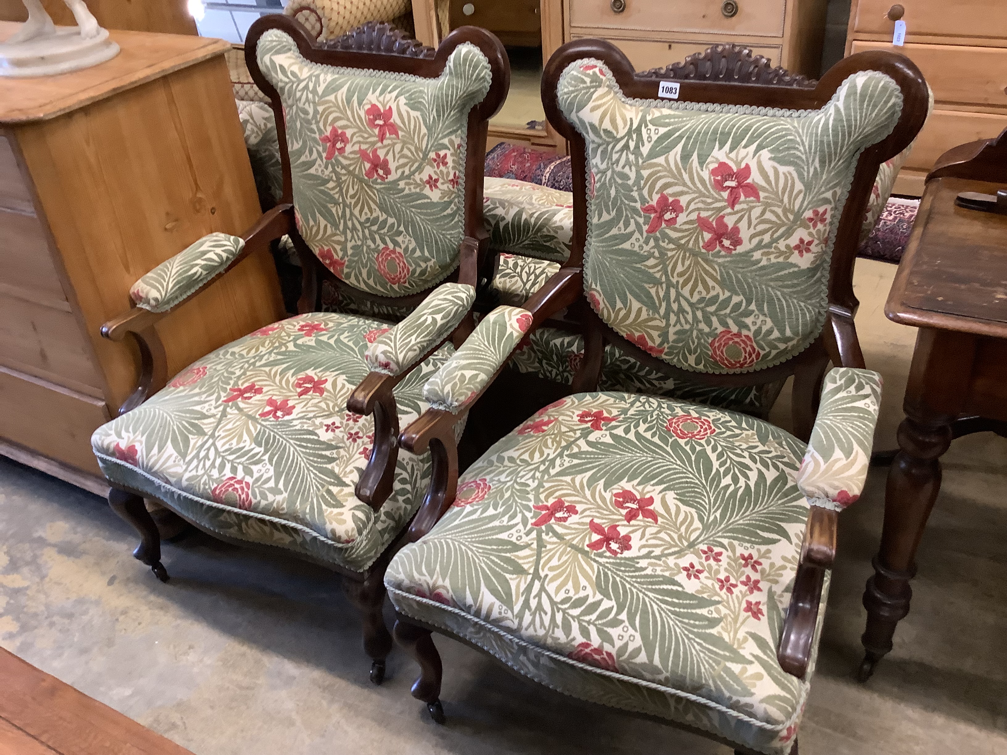 A pair of late Victorian mahogany upholstered armchairs